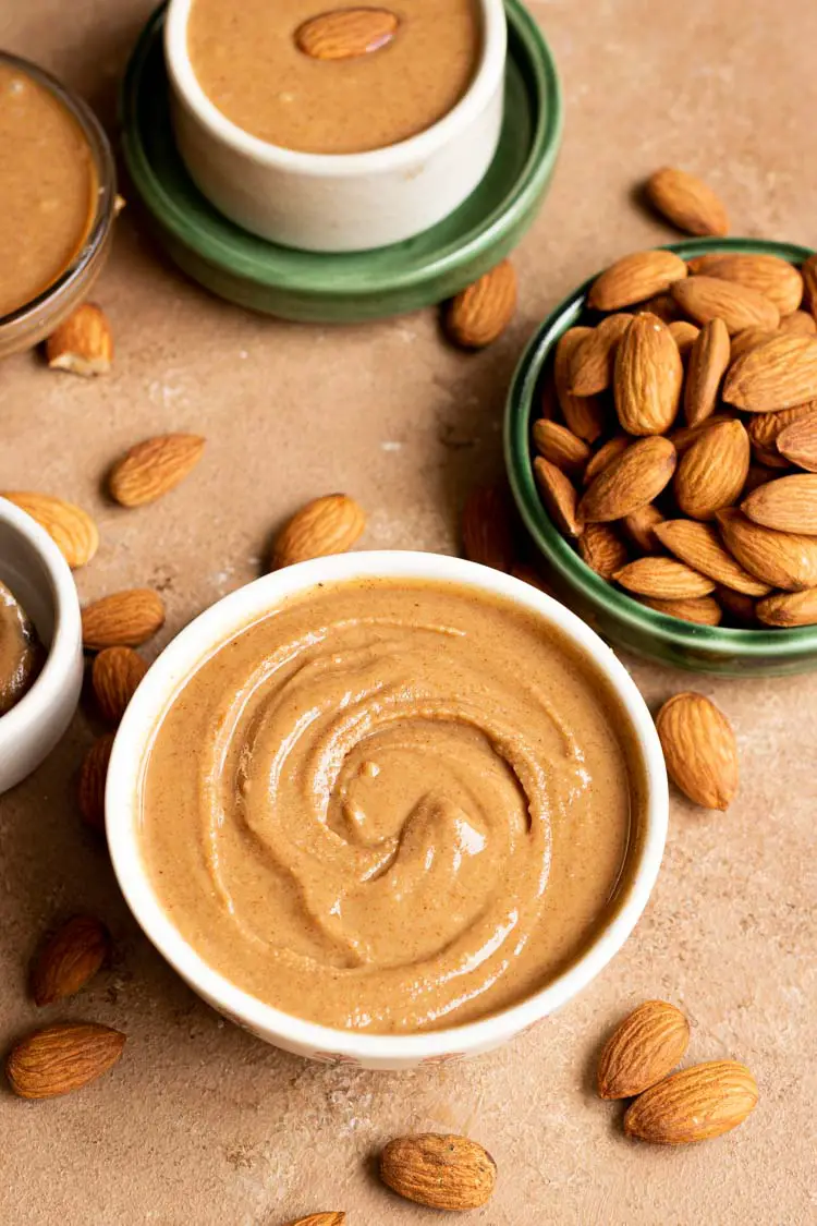 Raw Almond Butter Recipe, homemade almond butter recipe, almond butter in a serving bowl with some whole almonds