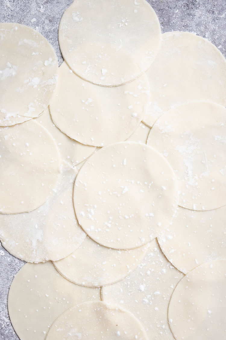 momo wrappers, momo dough recipe, discs of momo wrappers cut and laid on a surface 