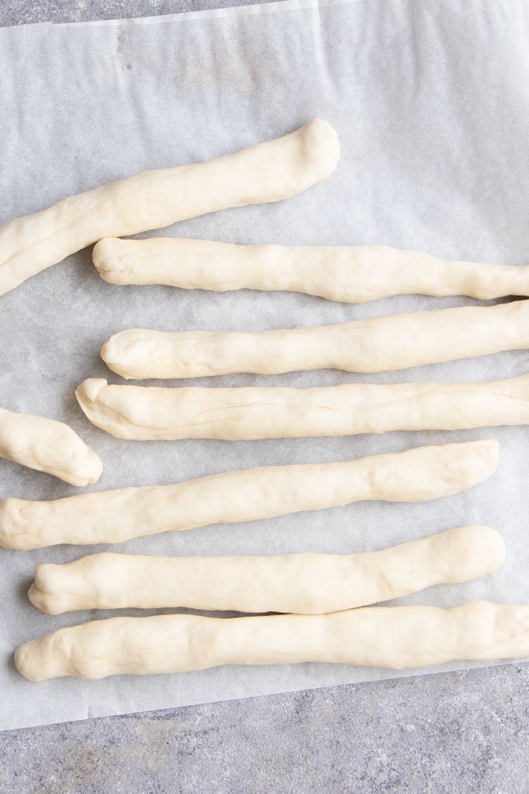 thin rolls of pizza dough laid on counter