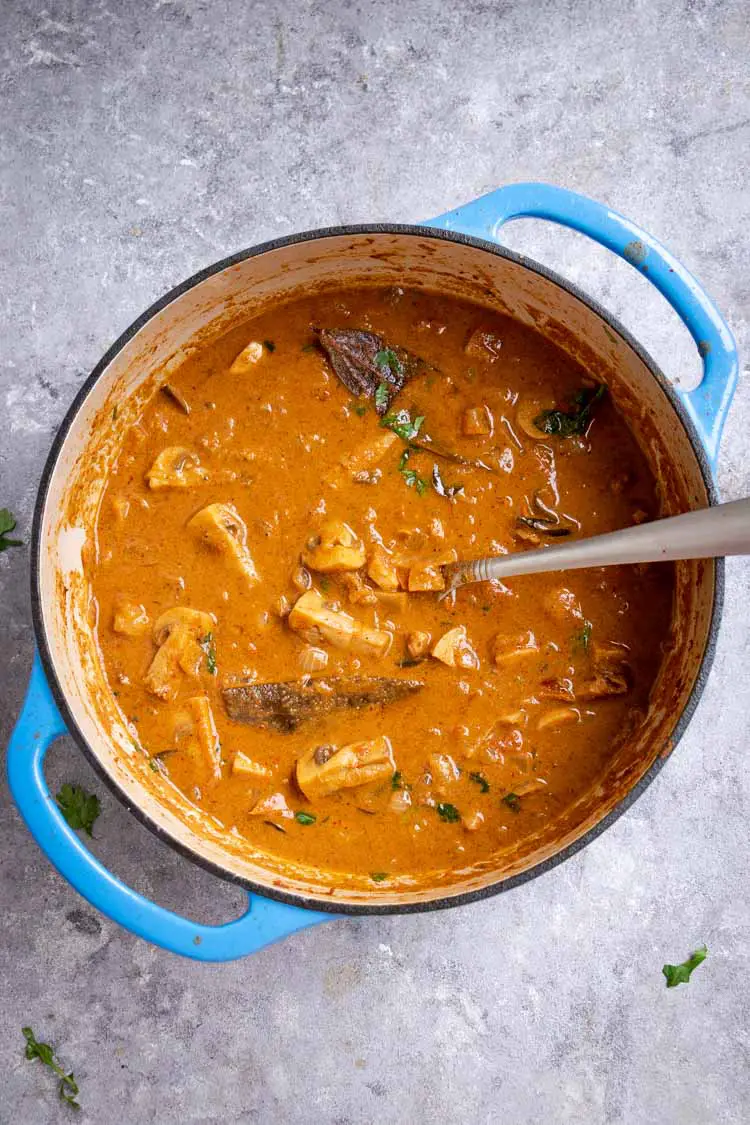 mushroom curry with coconut milk, creamy mushroom curry in a dutch oven