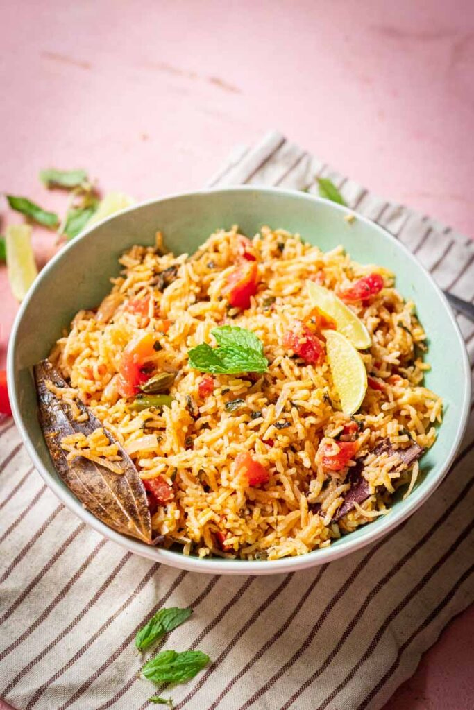 recipe for tomato rice, tomato biryani served in a bowl