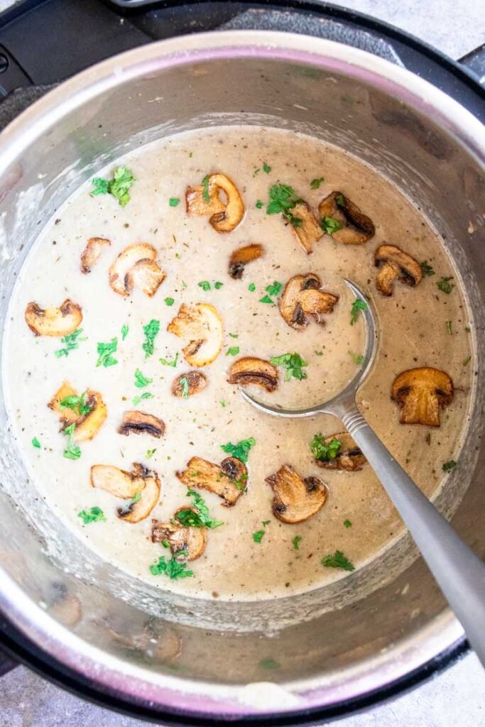 instant pot mushroom soup, an overhead shot of mushroom soup in instant pot