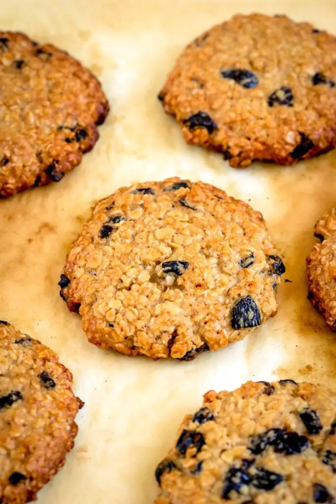 Oatmeal cookies spread on a parchment paper