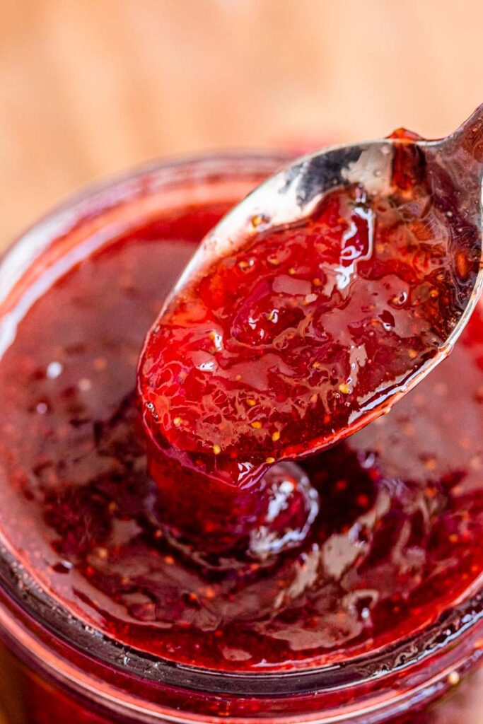 instant pot strawberry jam, strawberry jam recipe without pectin ,in a spoon from a jar