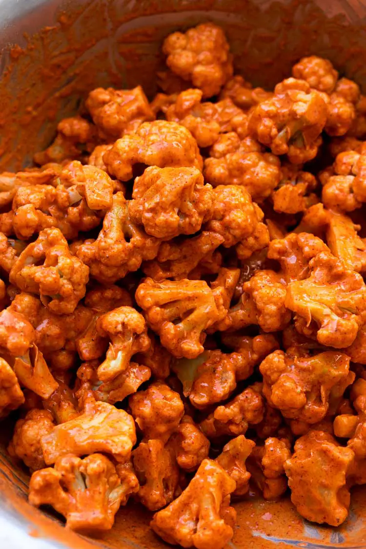 cauliflower florets in batter ready to be fried
