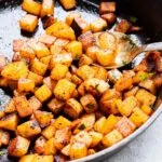 diced breakfast potatoes in a skillet cooked for breakfast