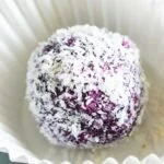 blueberry bliss ball in a white paper cup
