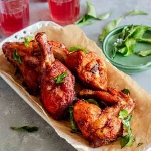 chicken drumsticks and wings fried in kerala style and served on a plate